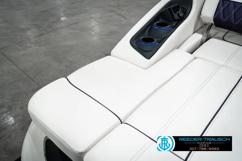 Slide: The Image of 2025 Bennington QX SB T2 boat interior with white seating and cup holders. - 36