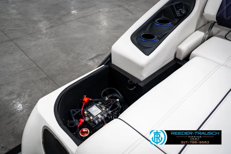 Slide: The Image of 2025 Bennington QX SB T2 boat interior with storage compartment and cup holders. - 37