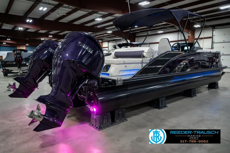Slide: The Image of 2025 Bennington QX SB T2 pontoon boat with dual Yamaha engines in showroom. - 8
