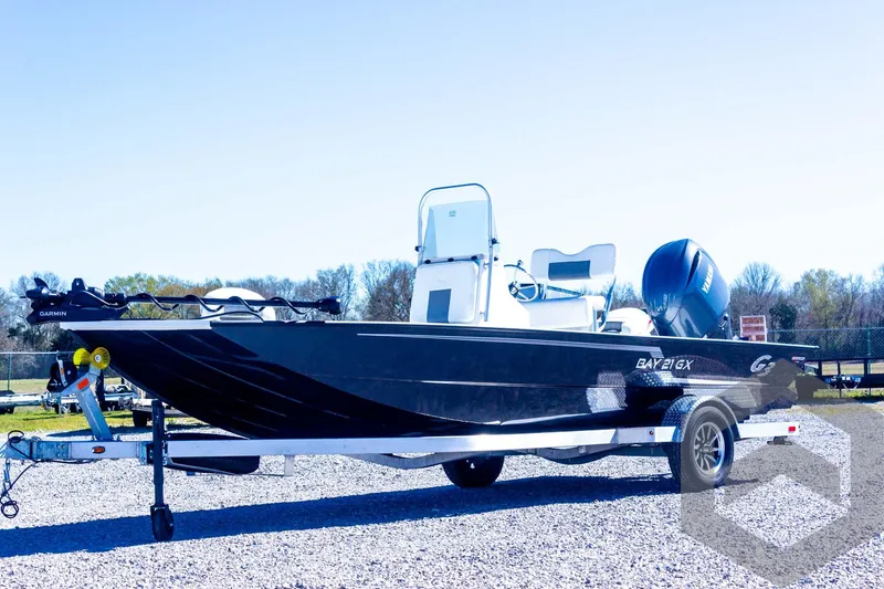 Slide: The Image of 2025 G3 Bay 21 GX boat on trailer, sleek design, outdoor setting. - 12
