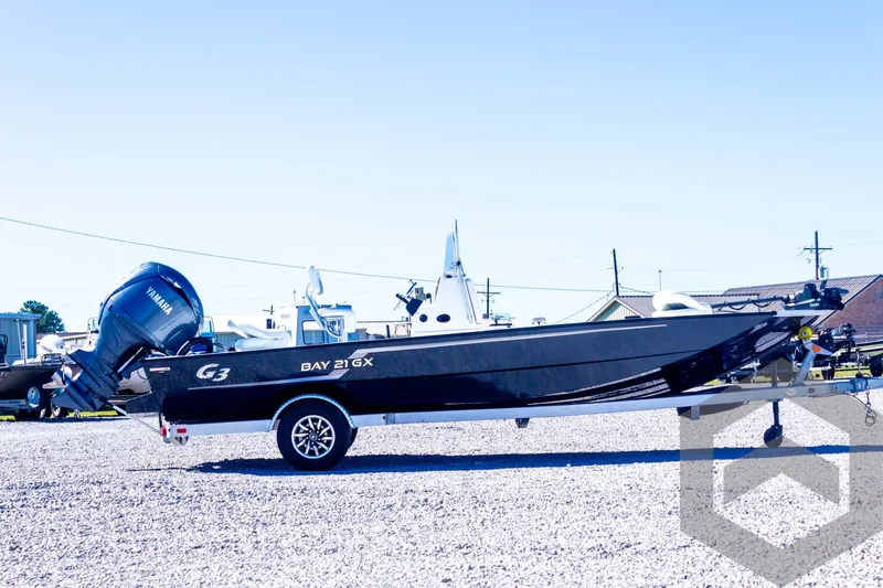 Slide: The Image of 2025 G3 Bay 21 GX boat on trailer, side view, outdoors. - 15