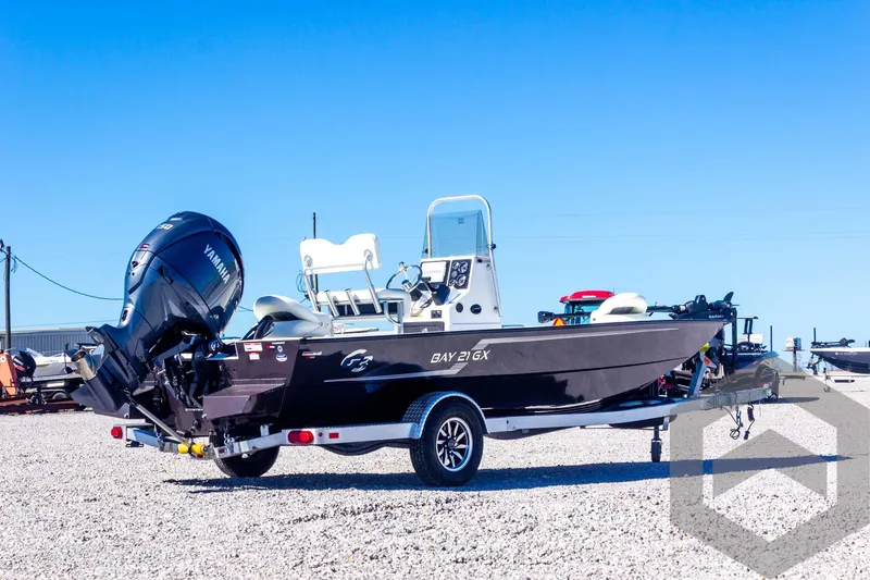 Slide: The Image of 2025 G3 Bay 21 GX boat on trailer, outdoor display, clear sky background. - 16