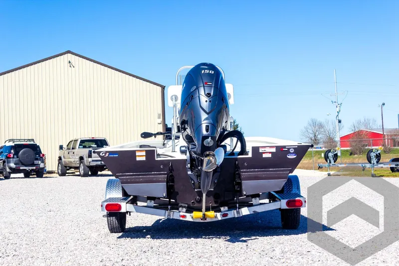 Slide: The Image of 2025 G3 Bay 21 GX boat on trailer, rear view, parked outdoors. - 17