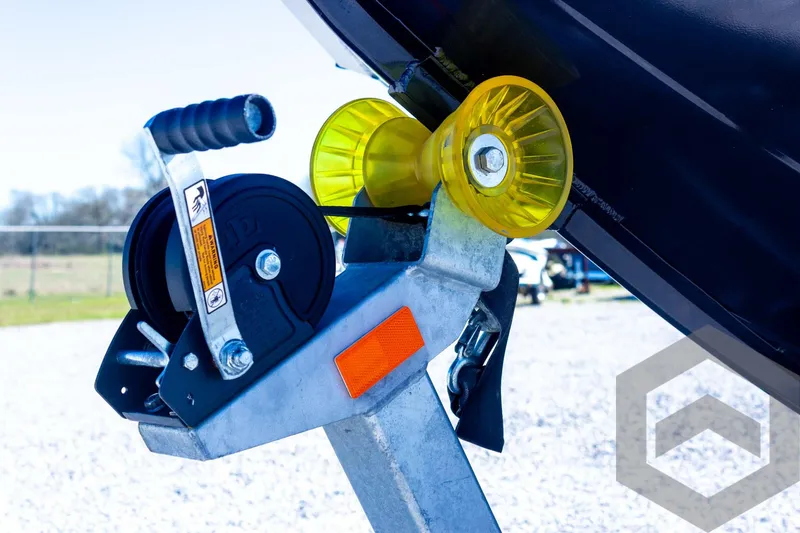 Slide: The Image of Trailer winch and roller of 2025 G3 Bay 21 GX boat on gravel surface. - 26