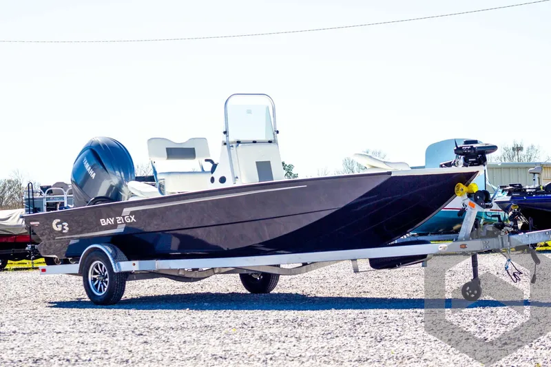 Slide: The Image of 2025 G3 Bay 21 GX boat on trailer, parked outdoors. - 3
