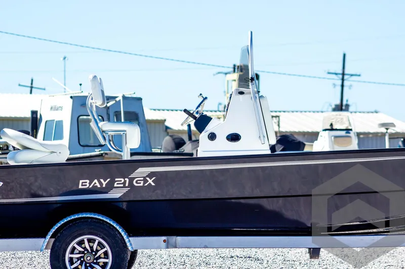 Slide: The Image of 2025 G3 Bay 21 GX boat on trailer, side view, outdoors. - 5
