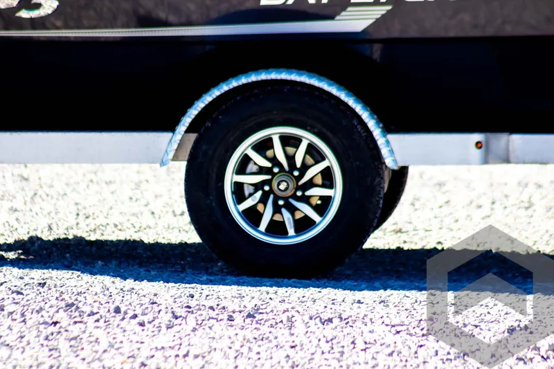 Slide: The Image of 2025 G3 Bay 21 GX trailer wheel on gravel surface. - 7