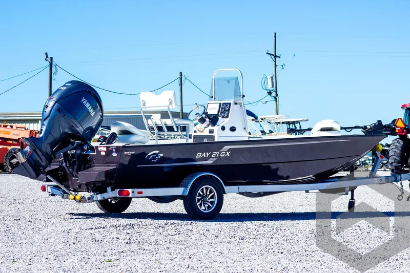 Slide: The Image of 2025 G3 Bay 21 GX boat on trailer with Yamaha outboard motor. - 8