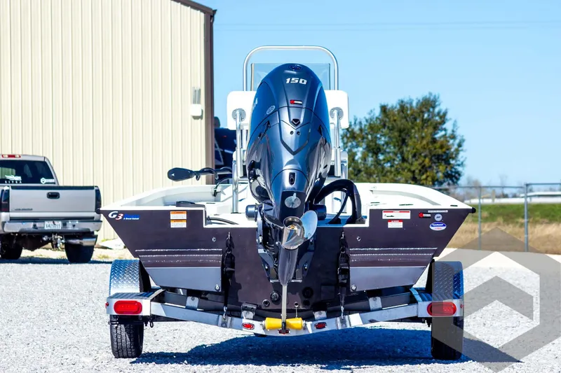 Slide: The Image of 2025 G3 Bay 21 GX boat on trailer, rear view with outboard motor. - 9