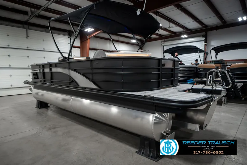 Slide: The Image of 2025 Bennington 23 LPD pontoon boat in showroom with black canopy. - 10