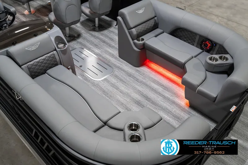 Slide: The Image of 2025 Bennington 23 LPD boat interior with gray seating and ambient lighting. - 13