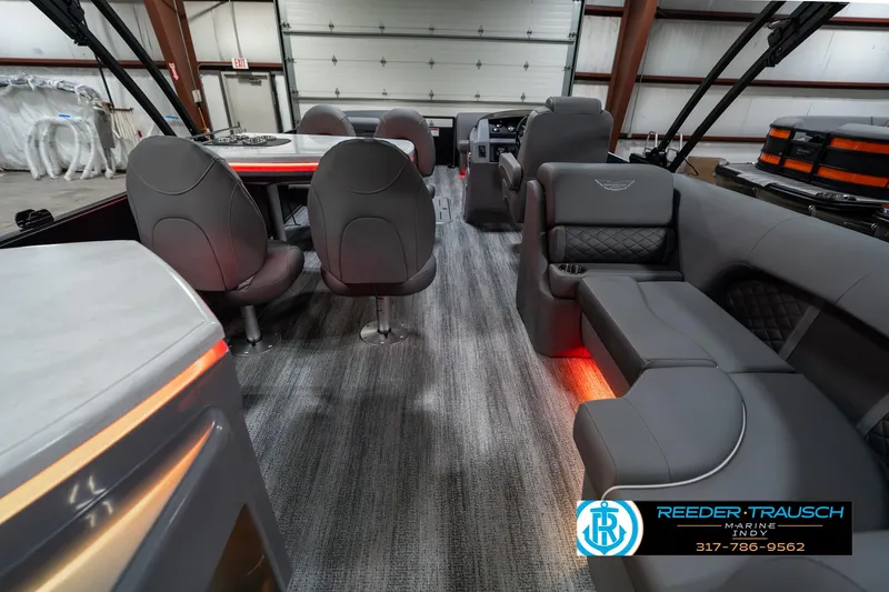 Slide: The Image of 2025 Bennington 23 LPD pontoon boat interior with modern seating and ambient lighting. - 19