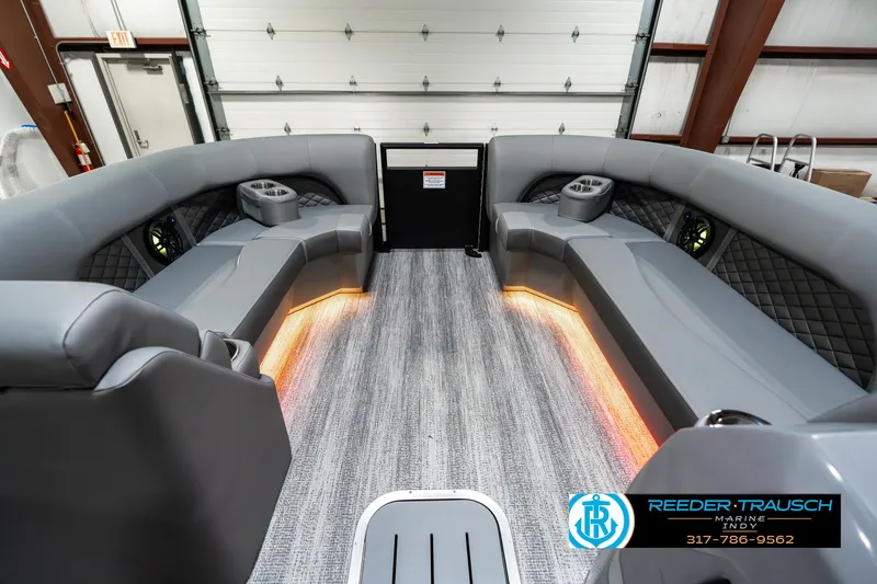 Slide: The Image of 2025 Bennington 23 LPD boat interior with gray seating and ambient lighting. - 21