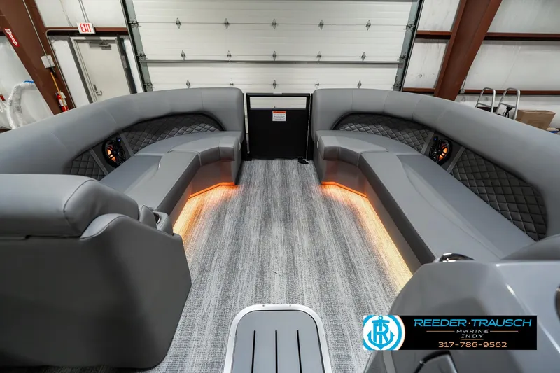 Slide: The Image of 2025 Bennington 23 LPD boat interior with gray seating and ambient lighting. - 22