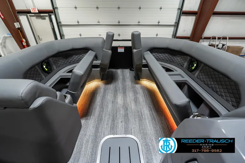 Slide: The Image of 2025 Bennington 23 LPD boat interior with gray seating and ambient lighting. - 23