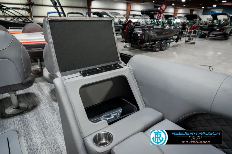 Slide: The Image of 2025 Bennington 23 LPD boat interior with storage compartment and cup holder. - 25