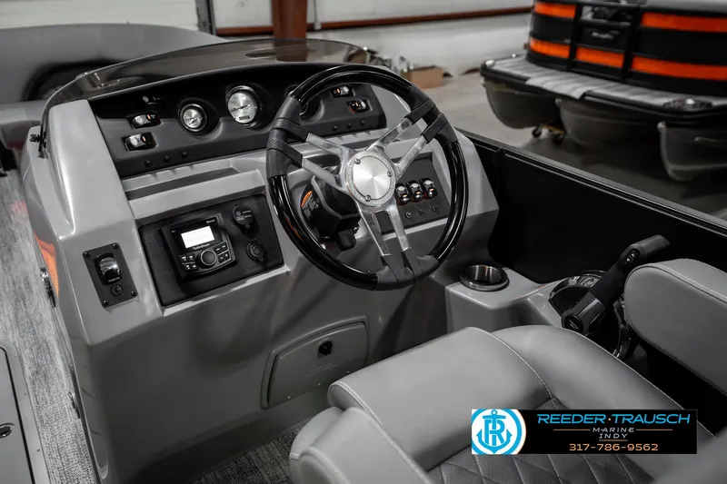 Slide: The Image of 2025 Bennington 23 LPD boat dashboard with steering wheel and control panel. - 31