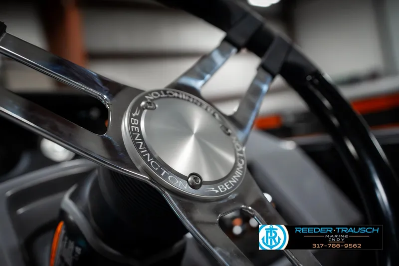 Slide: The Image of Steering wheel of 2025 Bennington 23 LPD boat, featuring sleek metallic design. - 32