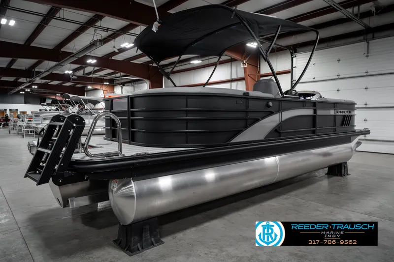 Slide: The Image of 2025 Bennington 23 LPD pontoon boat in showroom with black canopy. - 8