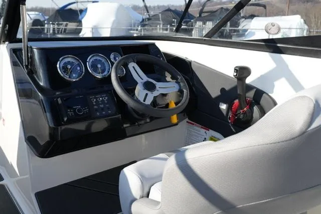 Slide: The Image of 2025 Bayliner V20 boat cockpit with steering wheel and control panel. - 14