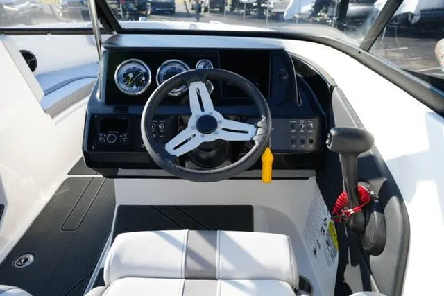 Slide: The Image of 2025 Bayliner V20 boat cockpit with steering wheel and control panel. - 15