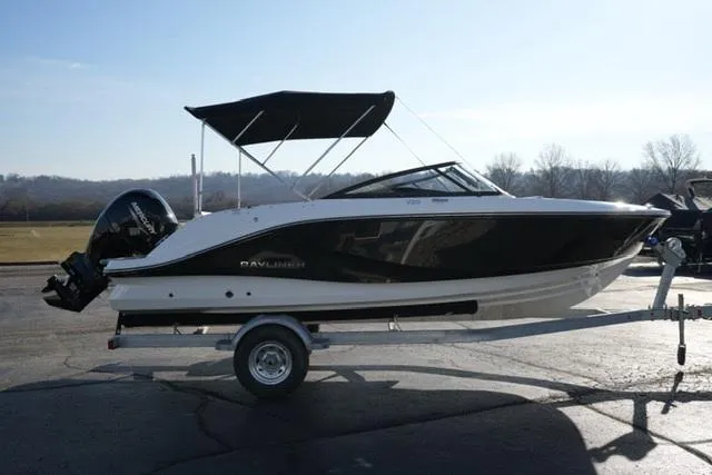 Slide: The Image of 2025 Bayliner V20 boat on trailer, black and white design, parked outdoors. - 5