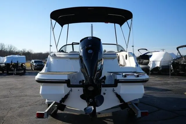 Slide: The Image of 2025 Bayliner V20 boat with outboard motor, parked on a trailer, under clear blue sky. - 7