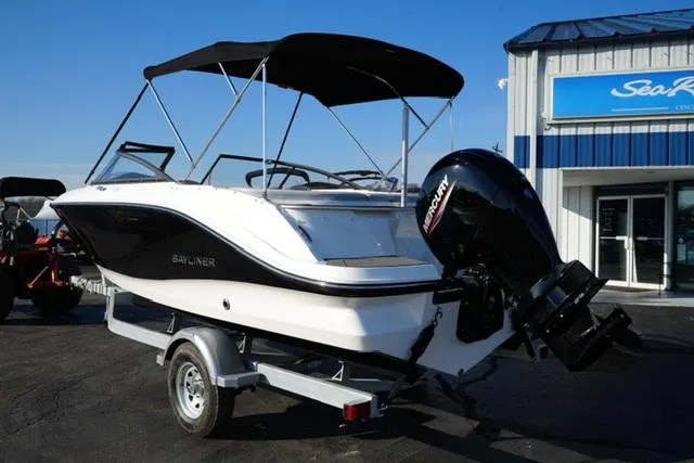 Slide: The Image of 2025 Bayliner V20 boat with outboard motor on trailer, parked outside dealership. - 8