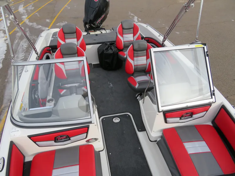 Slide: The Image of 2025 Ranger 1850MS boat interior with red and gray seating, open windshield, and motor. - 13