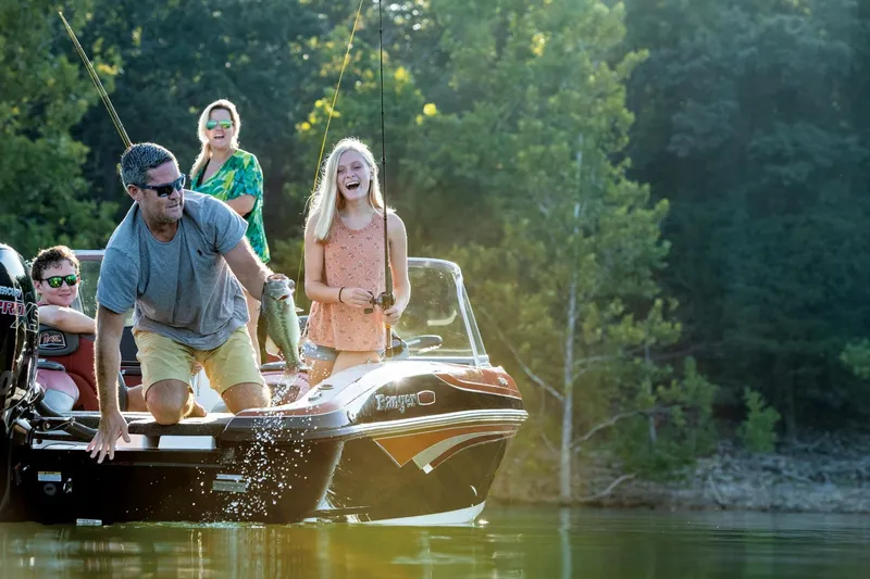Slide: The Image of Family enjoying fishing on a 2025 Ranger 1850MS boat in a scenic lake. - 15