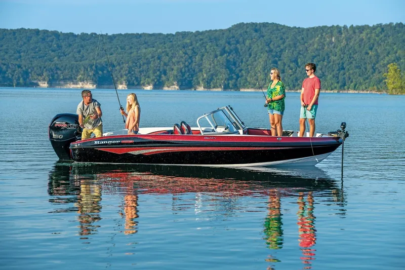 Slide: The Image of 2025 Ranger 1850MS boat on a lake with people fishing, surrounded by forested hills. - 16