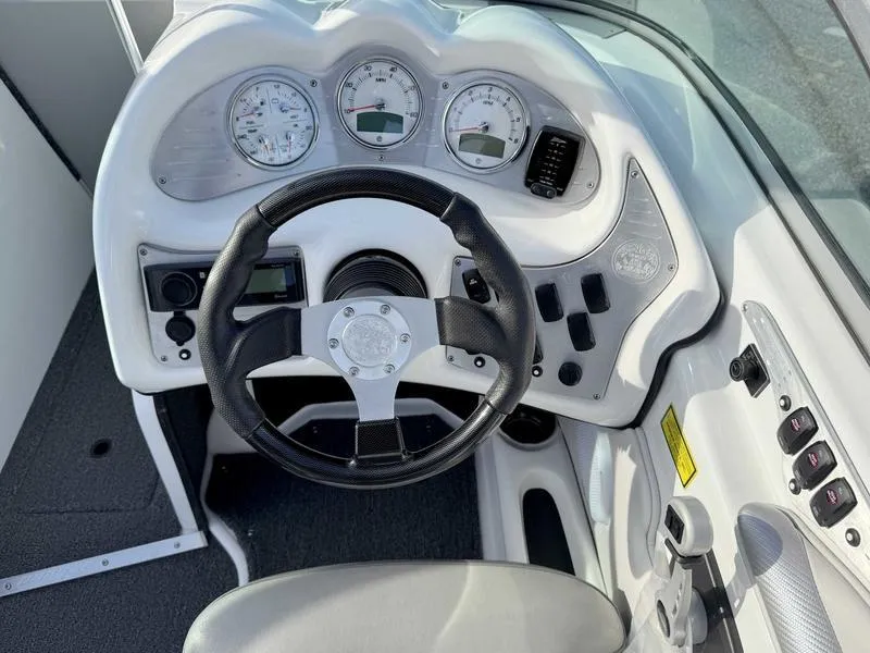 Slide: The Image of 2017 Sanger V215 XTZ boat dashboard with steering wheel and gauges. - 12