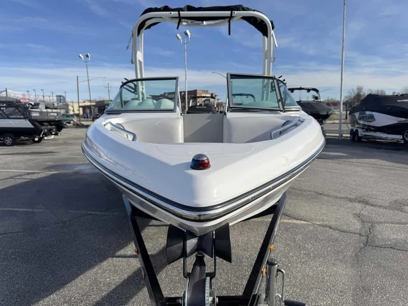 Slide: The Image of 2017 Sanger V215 XTZ boat on trailer, front view, in a parking lot. - 4