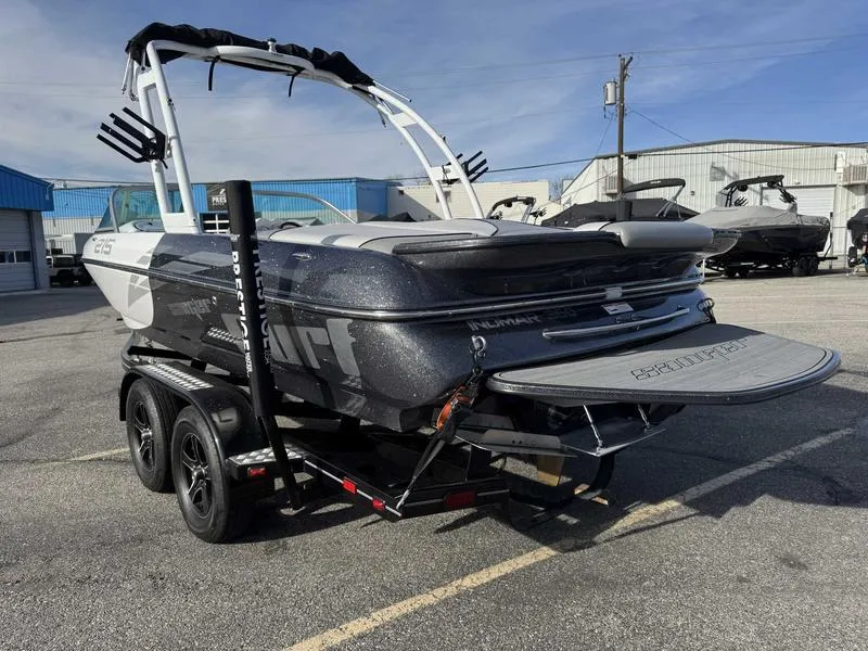 Slide: The Image of 2017 Sanger V215 XTZ boat on trailer, parked outdoors, showcasing sleek design and features. - 6