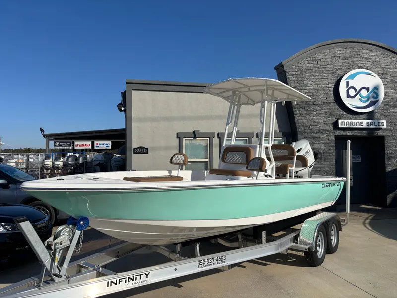 The Image of 2024 Clearwater 21 Bay boat on trailer at marine sales dealership. - 0