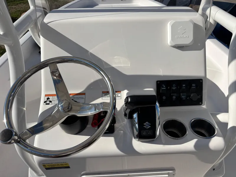 Slide: The Image of 2024 Clearwater 21 Bay boat console with steering wheel and controls. - 7