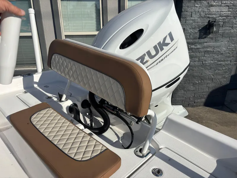 Slide: The Image of 2024 Clearwater 21 Bay boat with Suzuki engine and cushioned seating. - 8