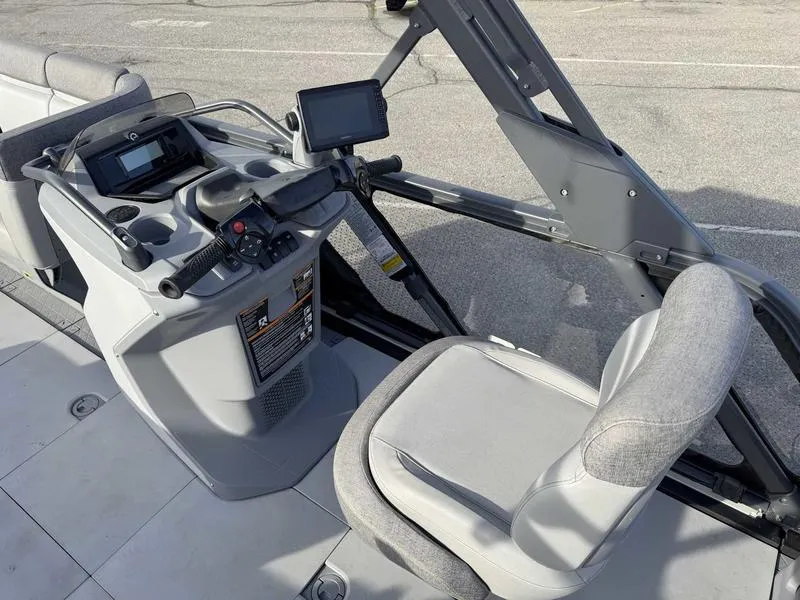 Slide: The Image of 2023 Sea-Doo Switch Cruise 18' dashboard and seating area, featuring modern controls and navigation. - 10
