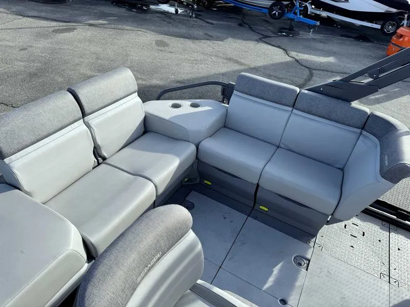 Slide: The Image of 2023 Sea-Doo Switch Cruise 18' interior with gray seating and cup holders. - 12