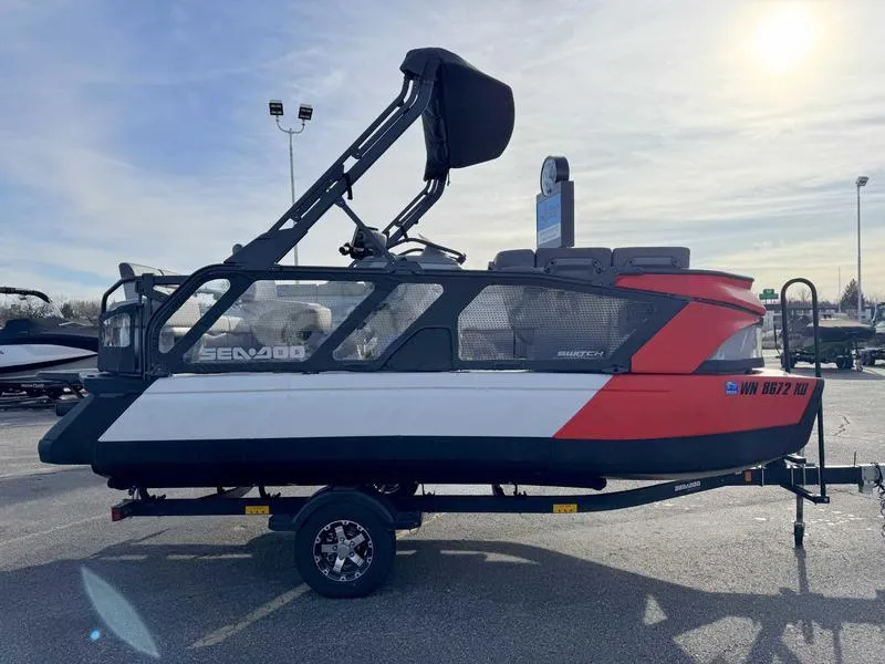 Slide: The Image of 2023 Sea-Doo Switch Cruise 18' pontoon boat on trailer, parked outdoors. - 5