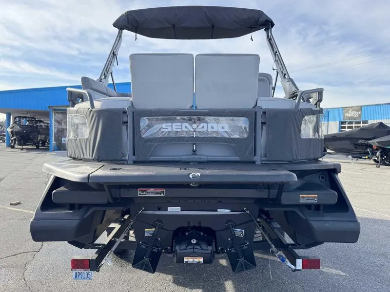 Slide: The Image of 2023 Sea-Doo Switch Cruise 18' pontoon boat, rear view, parked outdoors. - 8