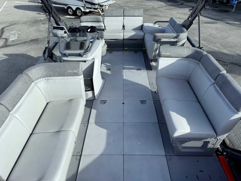 Slide: The Image of 2023 Sea-Doo Switch Cruise 18' pontoon boat interior with spacious seating and helm. - 9