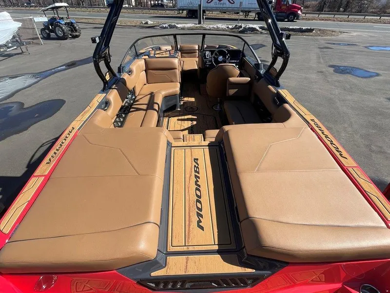 Slide: The Image of 2025 Moomba Max boat interior with tan seating and sleek design. - 14