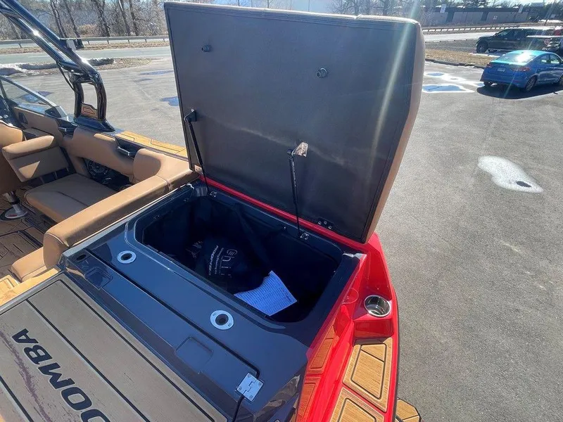 Slide: The Image of 2025 Moomba Max boat with open storage compartment, showcasing interior features. - 15