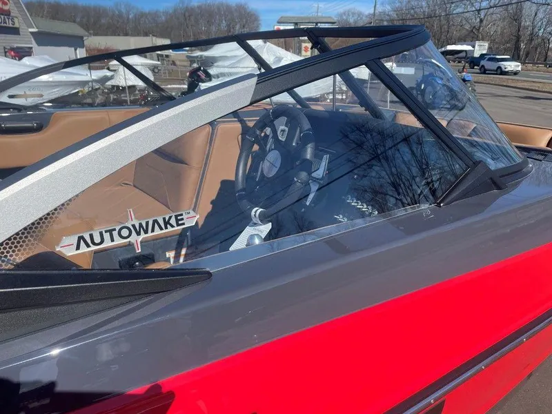 Slide: The Image of 2025 Moomba Max boat interior with Autowake feature, showcasing steering wheel and seating. - 18