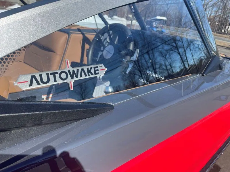 Slide: The Image of 2025 Moomba Max boat with Autowake feature, showcasing sleek interior and steering wheel. - 20