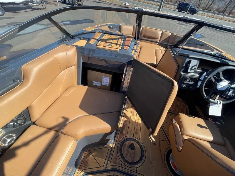 Slide: The Image of Interior of 2025 Moomba Max boat with tan seating and modern dashboard. - 23