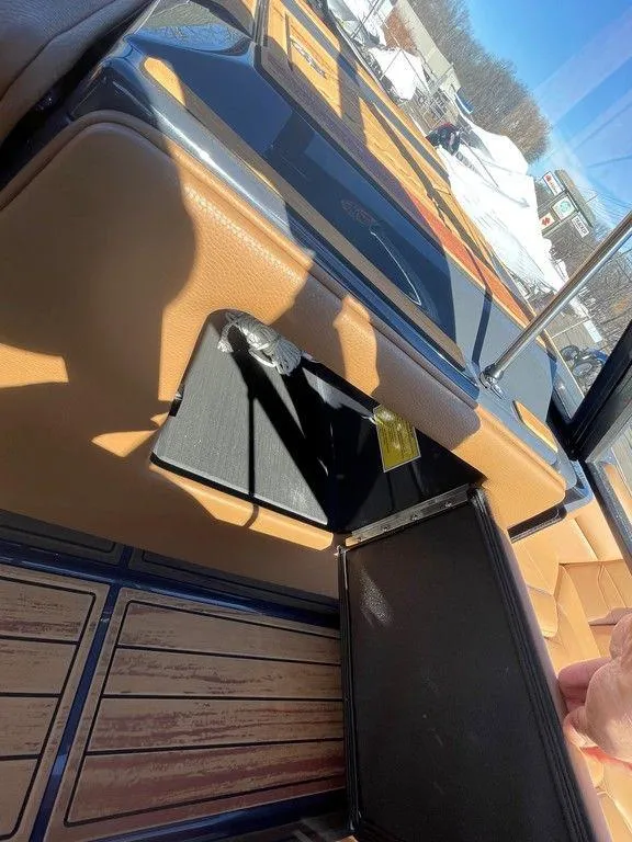 Slide: The Image of 2025 Moomba Max interior detail with tan upholstery and wooden flooring. - 24