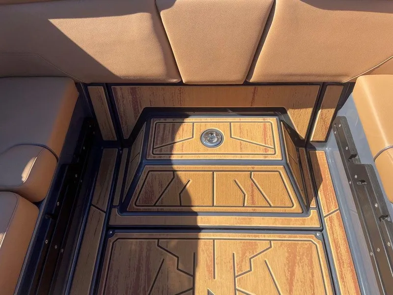 Slide: The Image of 2025 Moomba Max boat interior with stylish wood paneling and cushioned seating. - 28