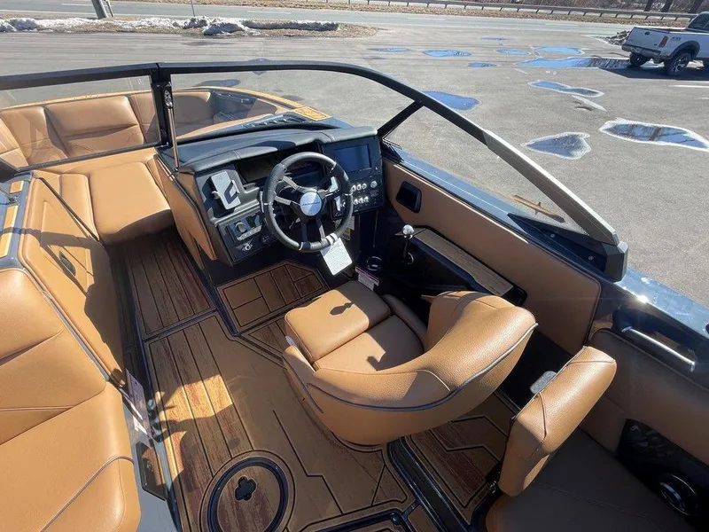 Slide: The Image of 2025 Moomba Max boat interior with tan leather seats and modern dashboard. - 30